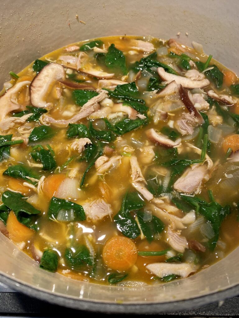 chicken soup with spinach, carrot, ginger, garlic, onion, shiitake mushrooms, spices